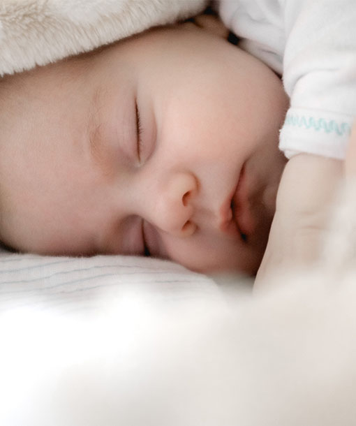 Portrait Photo of Sleeping Baby after Being Taken Care of by a Nanny from Petite Crew