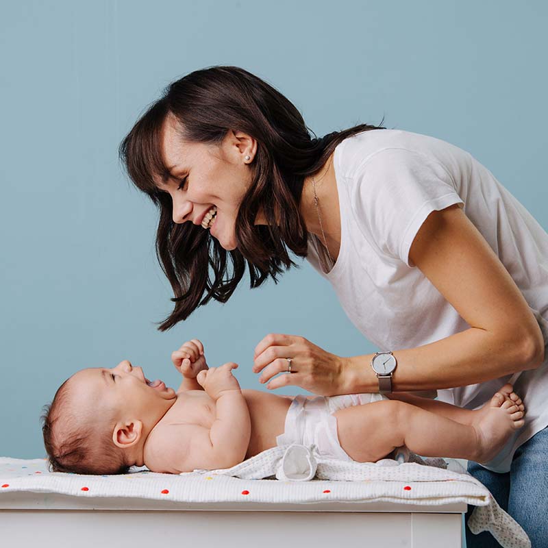 Portrait Photo of Caregiver Changing a New-born on the Changing Table at Petite Crew